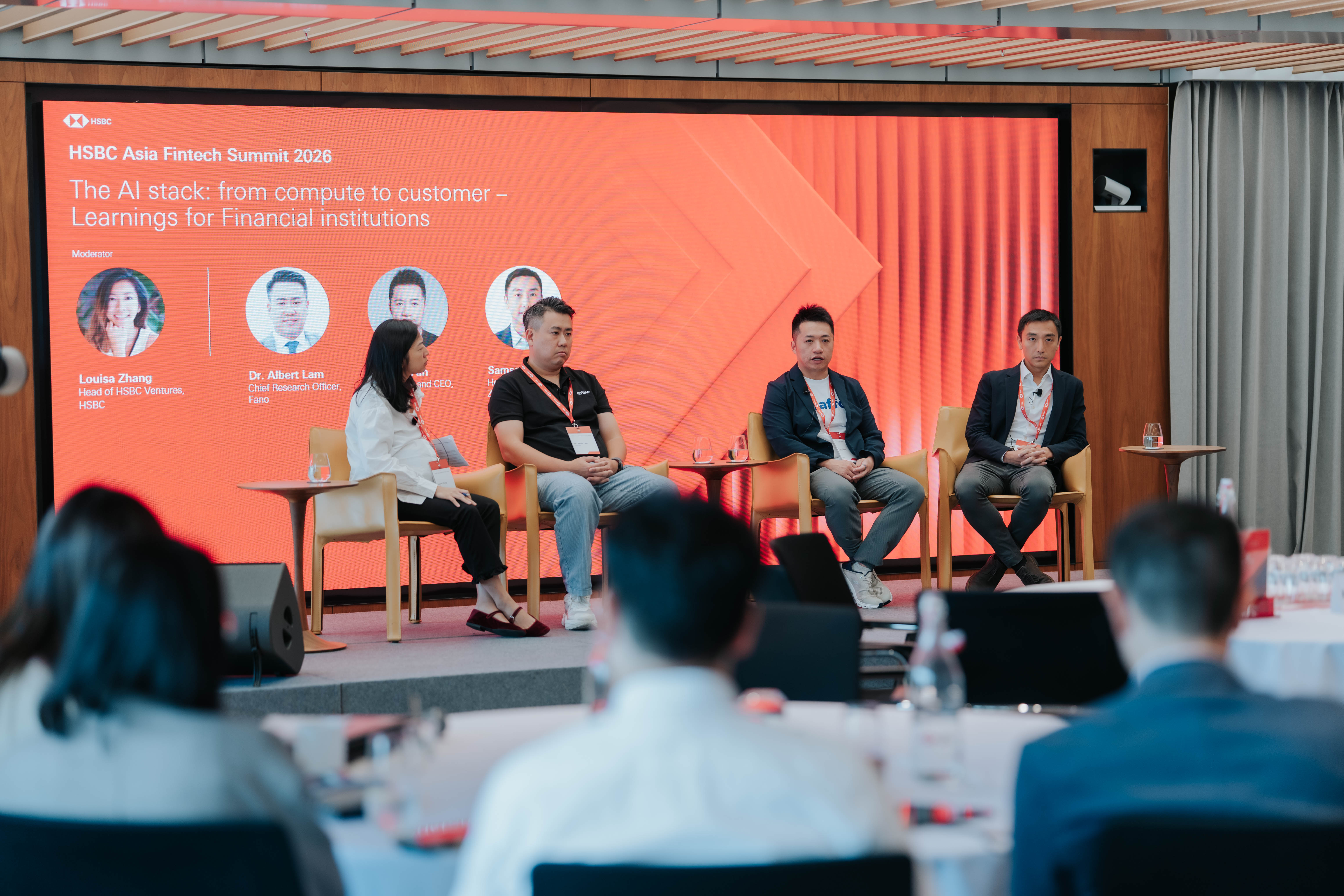 Four panelists seated on stage in front of a large red HSBC screen at the HSBC Asia Fintech Summit 2026 in Hong Kong, during a session titled The AI stack: from compute to customer. Samson C. of Zettabyte sits at the far right, with delegates seated at tables in the foreground.